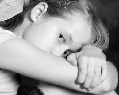 Little girl in a mood with her head down