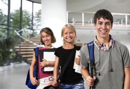 Three smiling students in a safe school