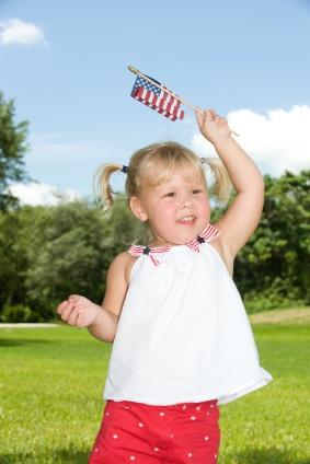 Young girl waving American flag