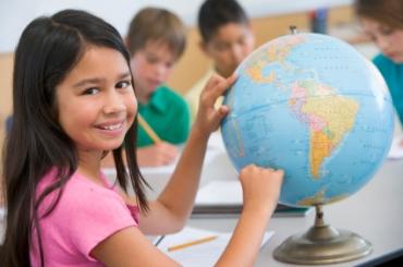 girl looking at globe