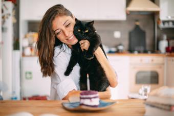 Cute Woman Celebrating Her Birthday With Her Black Cat 