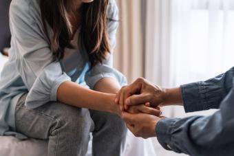 Young man comforting sad woman