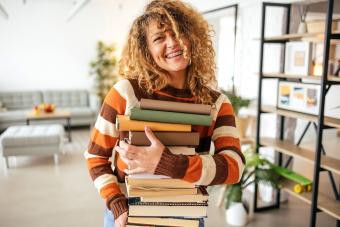 woman holding books in her hands