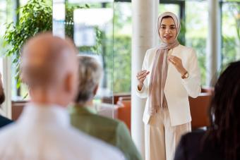 businesswoman addressing the audience in a conference