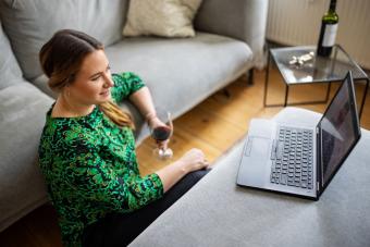 Woman with wine having online date