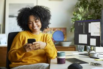 woman using smart phone at home office