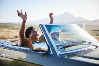 Happy older couple on a scenic drive in a convertible