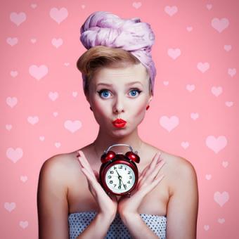 Beautiful woman holding clock