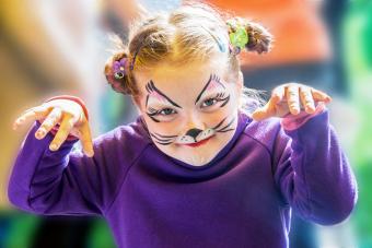 Funny little girl with cat painted face