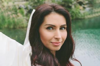 model with angel wings and in a white dress and glossy lips