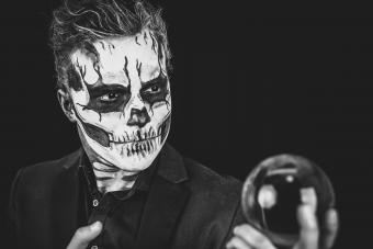 Young Man With Spooky Make-Up Holding Crystal Ball