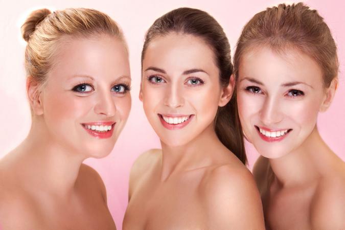 three beautiful women wearing makeup