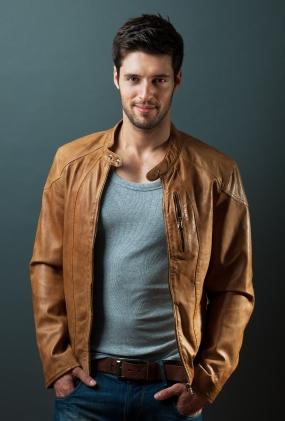 man in leather jacket, denim, and casual shirt