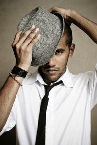 man tilting fedora
