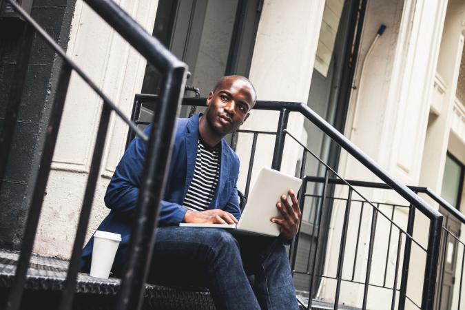 Fashionable man seated on steps