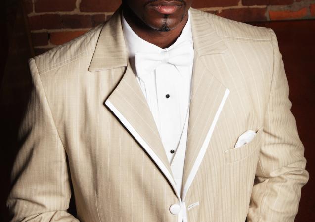 Man in a tan tuxedo suit