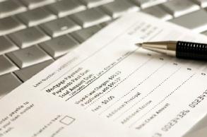 Monthly mortgage payment coupon on laptop