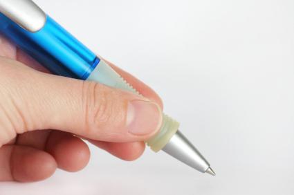 Hand holding blue pen