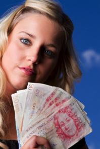 woman holding British Pounds