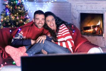 couple laughing and watching Christmas movie