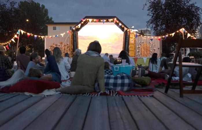 Crowd enjoying movie in the park