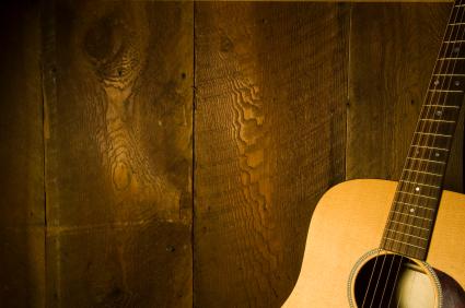Acoustic guitar on wood wall