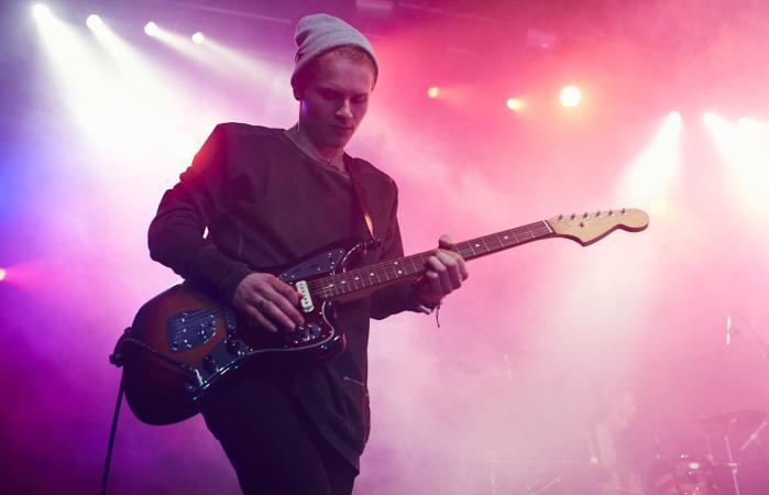 Guitarist performing on stage at music concert