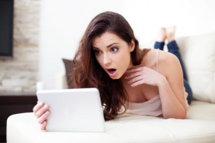 Surprised woman looking at tablet