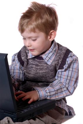 Child playing on a laptop.