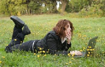 woman using laptop in field