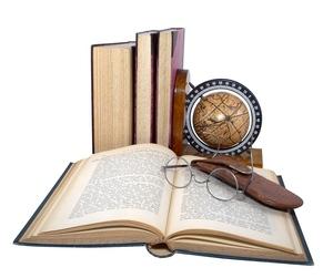 scholarly display of books globe, and glasses