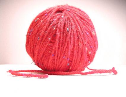 Spool of red yarn.