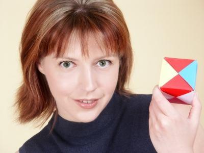 Woman with origami cube