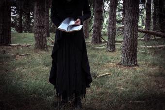 Bizarre Woman Reading A Book In The Forest