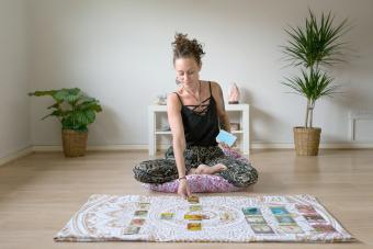 Woman reading tarot cards in spiritual room