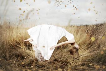 Young woman levitating in autumn field