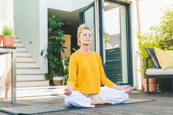 woman meditating on terrace