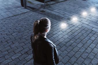 Young woman in front of glowing orbs