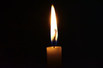 Close-Up Of Lit Candle In Darkroom