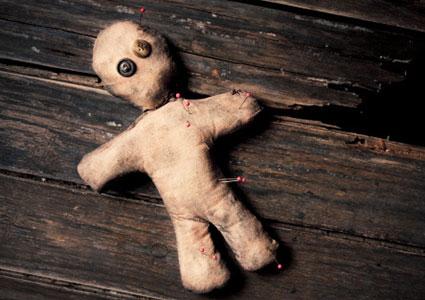 Voodoo doll with pins