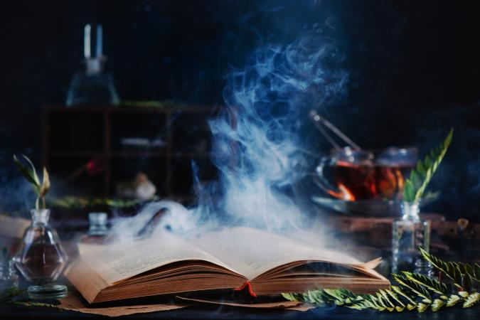 spell book with magical smoke