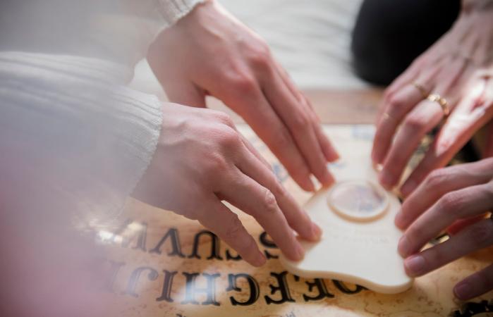 women using a Ouija board