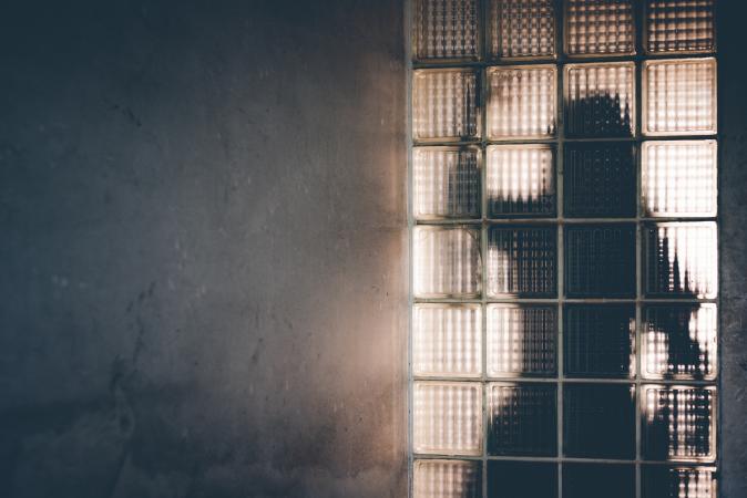 Shadow of woman behind a glass wall