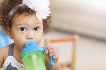 little girl with sippy cup 