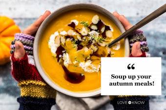 Girl's hands holding bowl of creamed pumpkin soup