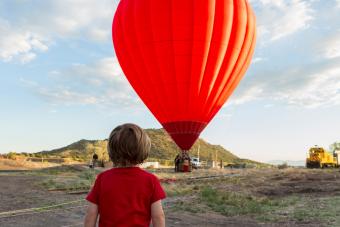 Boy watching distant hot air balloon