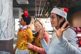 Modern and serene businesswomen dancing during Christmas office party