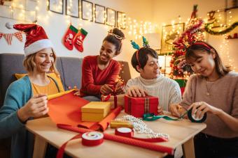 friends wrapping Christmas gifts together