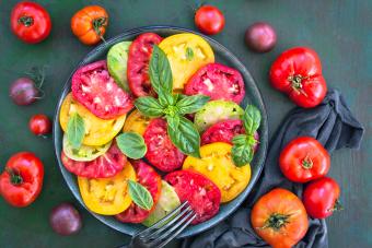 Fresh red and yellow tomato salad with basil