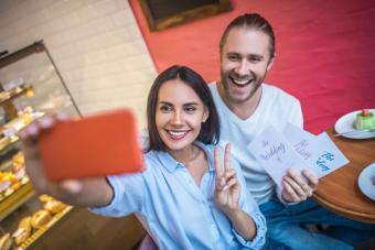 Couple making photo with wedding invitations